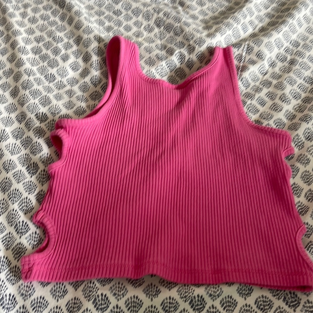 I am selling a pink crop top with little holes for fashion on the sides!